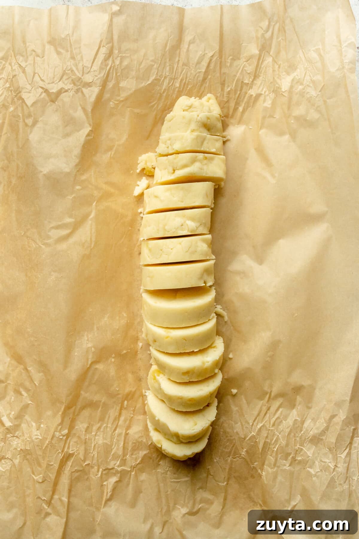 White Chocolate Peppermint Icebox Cookies Recipe 8 Chilled sliced cookies sit on parchment paper.