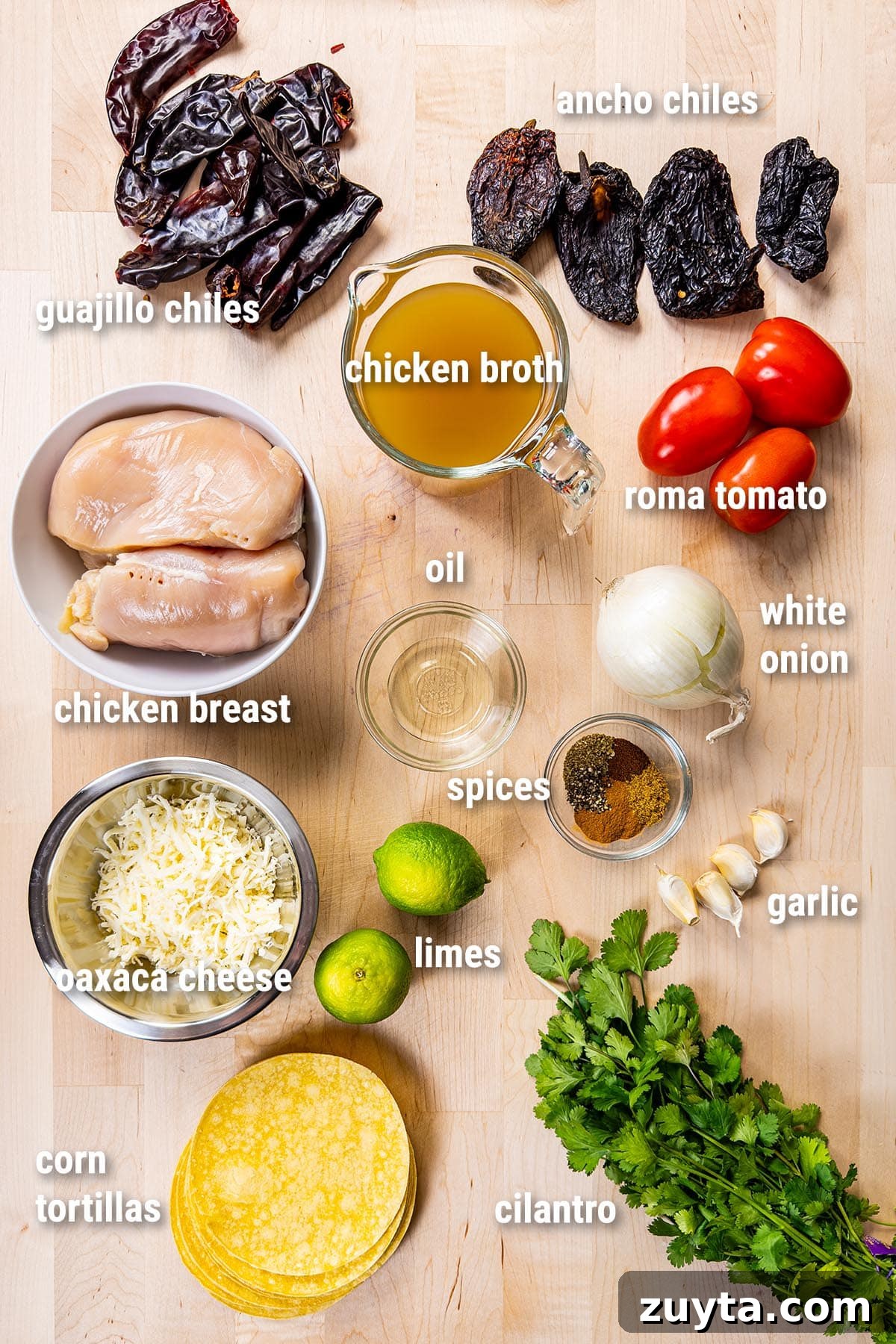 Chicken Birria Tacos Recipe with Consommé 2 Raw, uncooked chicken birria tacos ingredient laid out on a wooden cutting board.