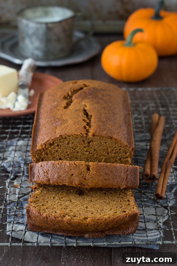 Copycat Starbucks Pumpkin Bread Recipe 6 pumpkin bread loaf sliced into 2 pieces on metal cooling rack