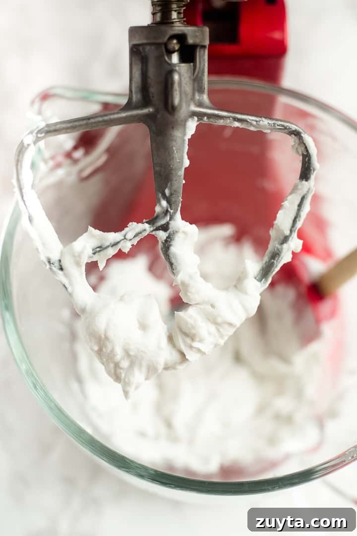 Whipped coconut cream in mixing bowl