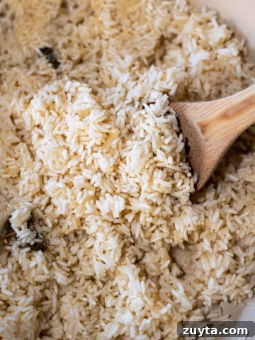 Closeup of rice pilaf with wooden spoon.