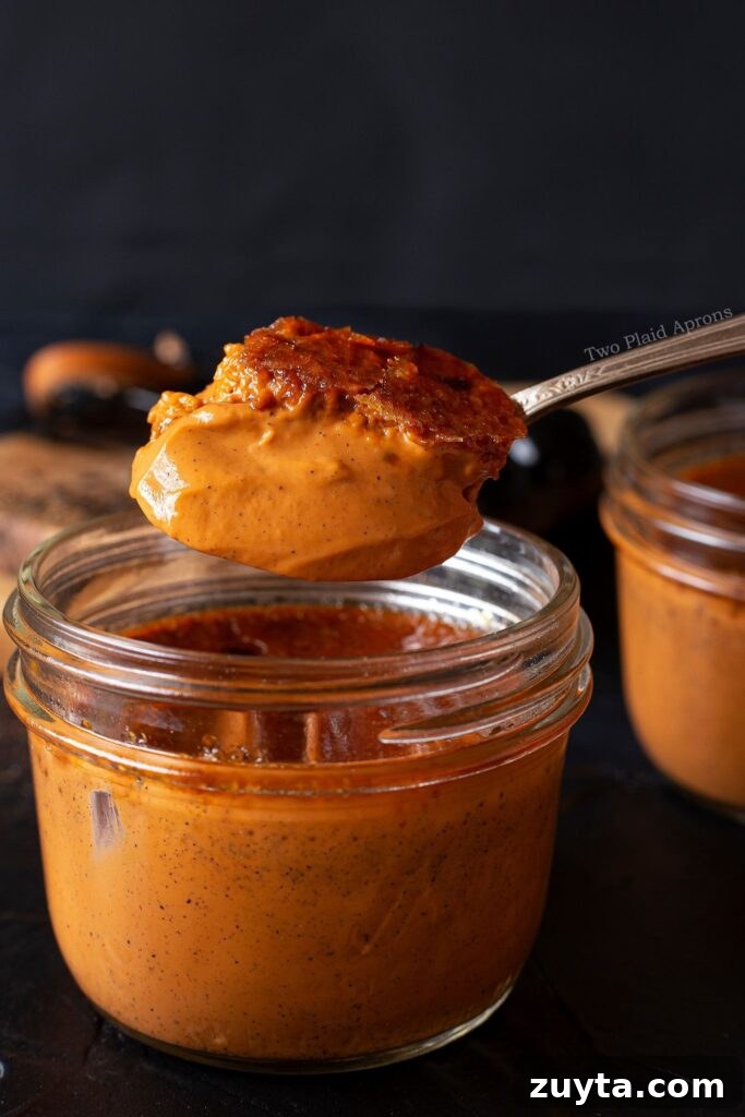 Silky Thai Tea Crème Brûlée Recipe 4 A spoonful of Thai tea crème brûlée showing silky smooth texture.