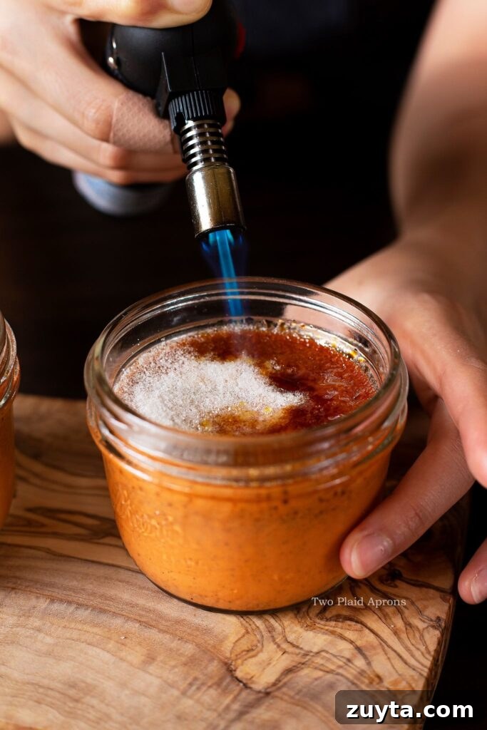 Silky Thai Tea Crème Brûlée Recipe 6 Brûléeing the sugar on the crème brûlée to caramelize.