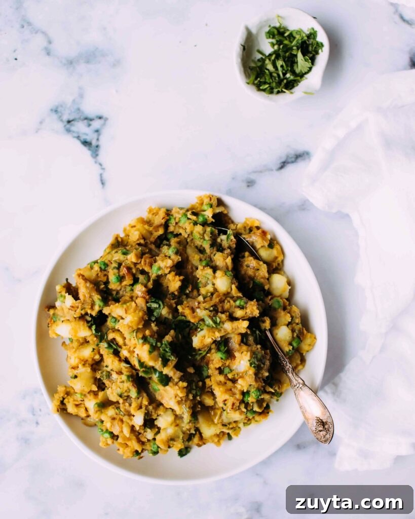 Homemade Samosa Filling: Spiced Potato and Pea Mix 4 Potato samosa filling in a bowl with a spoon.