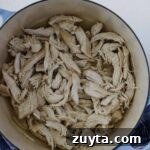 A Dutch oven with pulled chicken.
