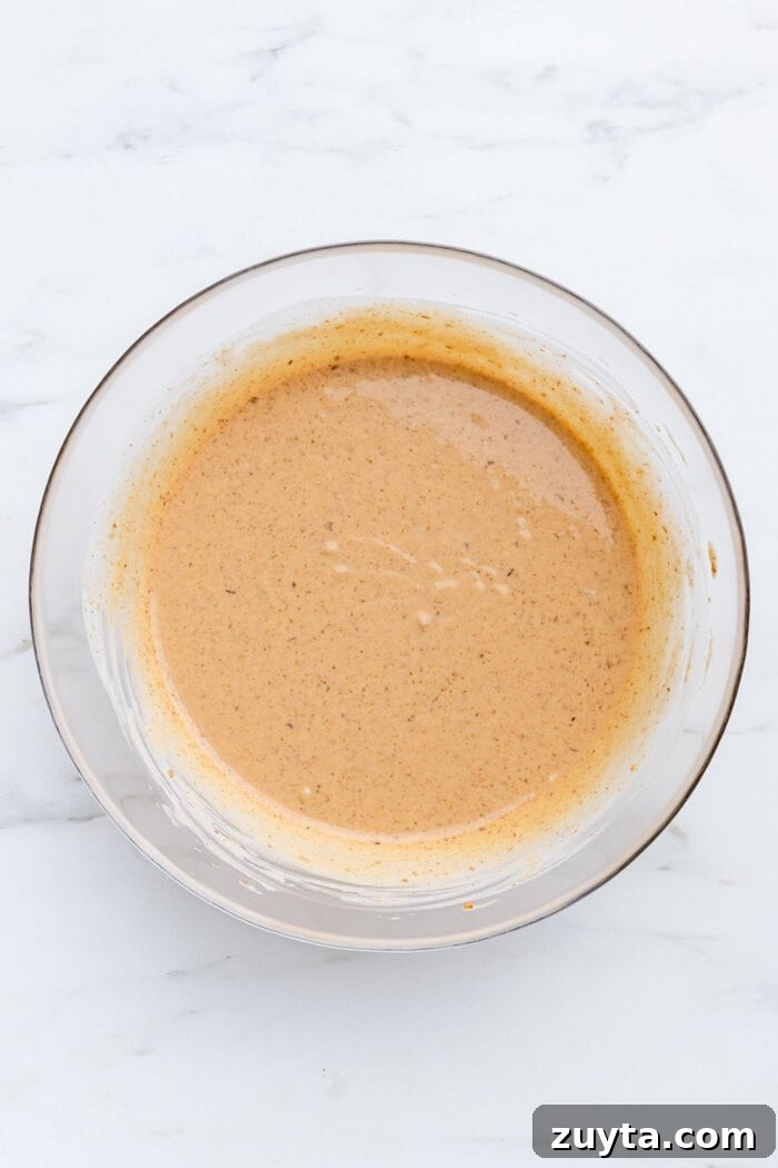Creamy No-Bake Vegan Peanut Butter Pie 5 A thick peanut butter mixture in a large mixing bowl.