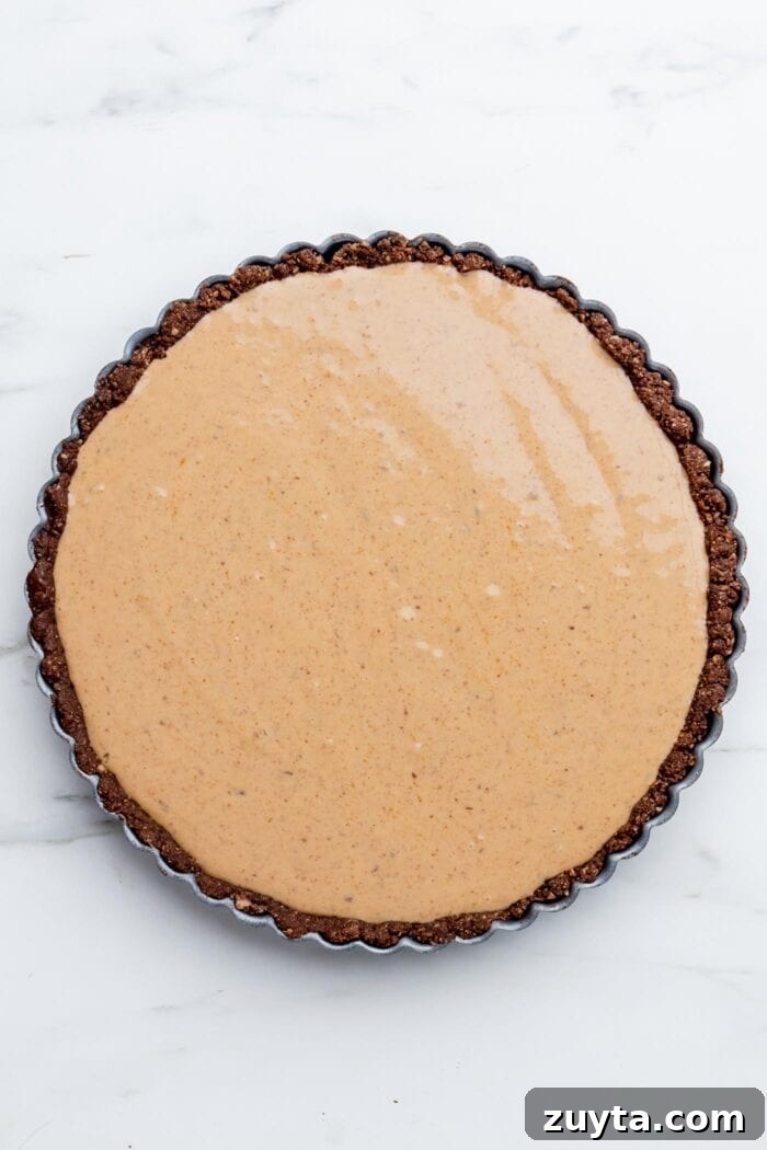 Creamy No-Bake Vegan Peanut Butter Pie 6 Overhead view of a peanut butter pie with a chocolate crust.