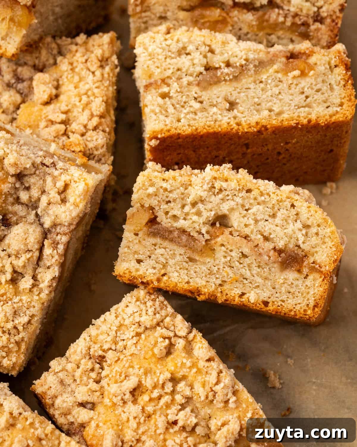 Moist Apple Cinnamon Coffee Cake Recipe 2 Several slices of apple cinnamon coffee cake sitting on a marble counter.