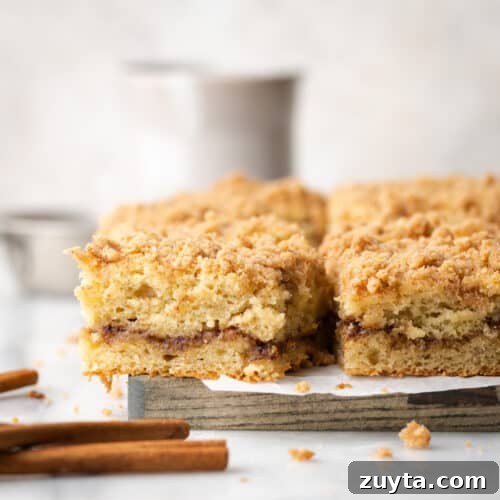 Slices of banana bread coffee cake on a wooden cutting board.