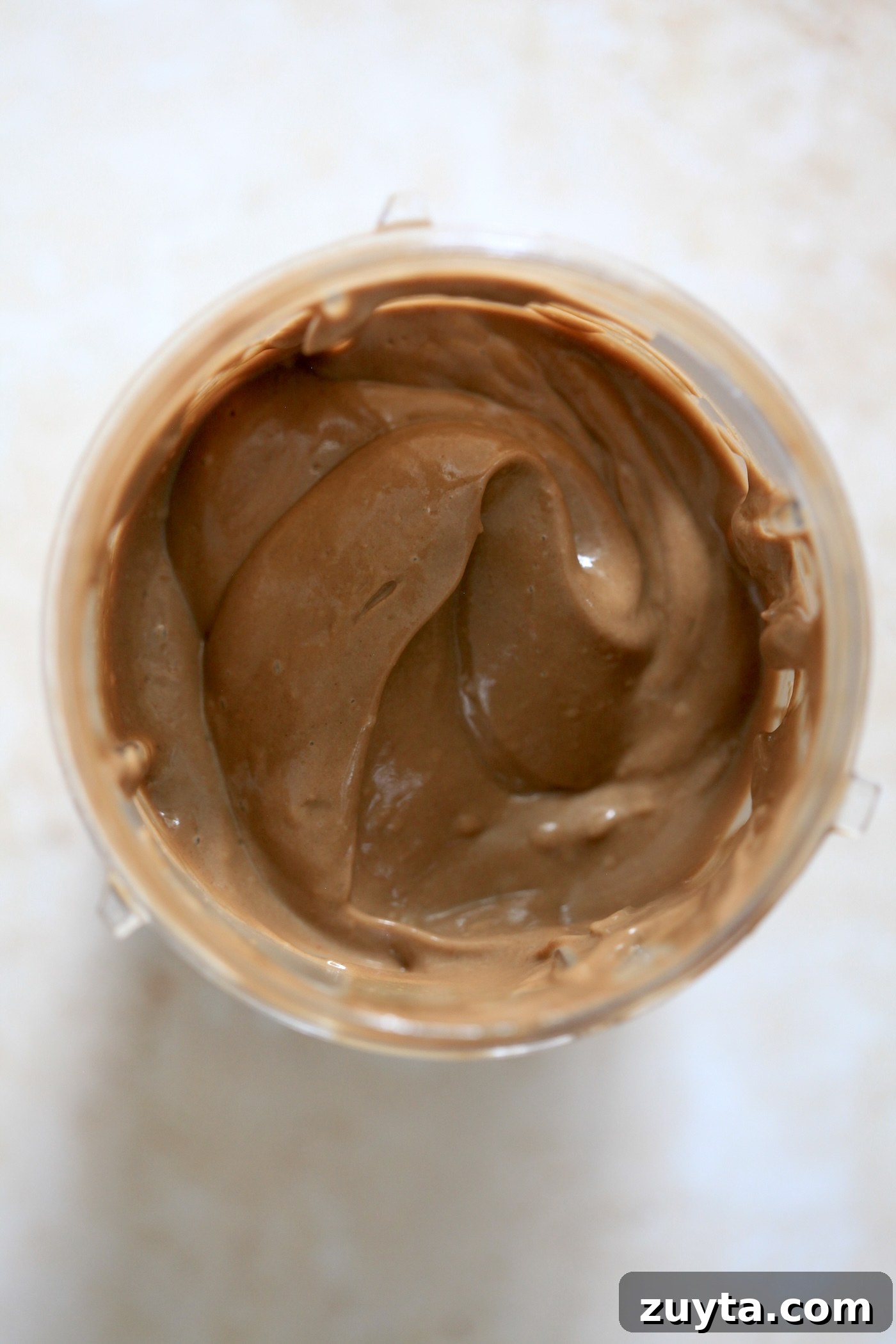 Creamy Dairy-Free Chocolate Avocado Ice Cream Recipe 3 brown blended mixture in blender jar