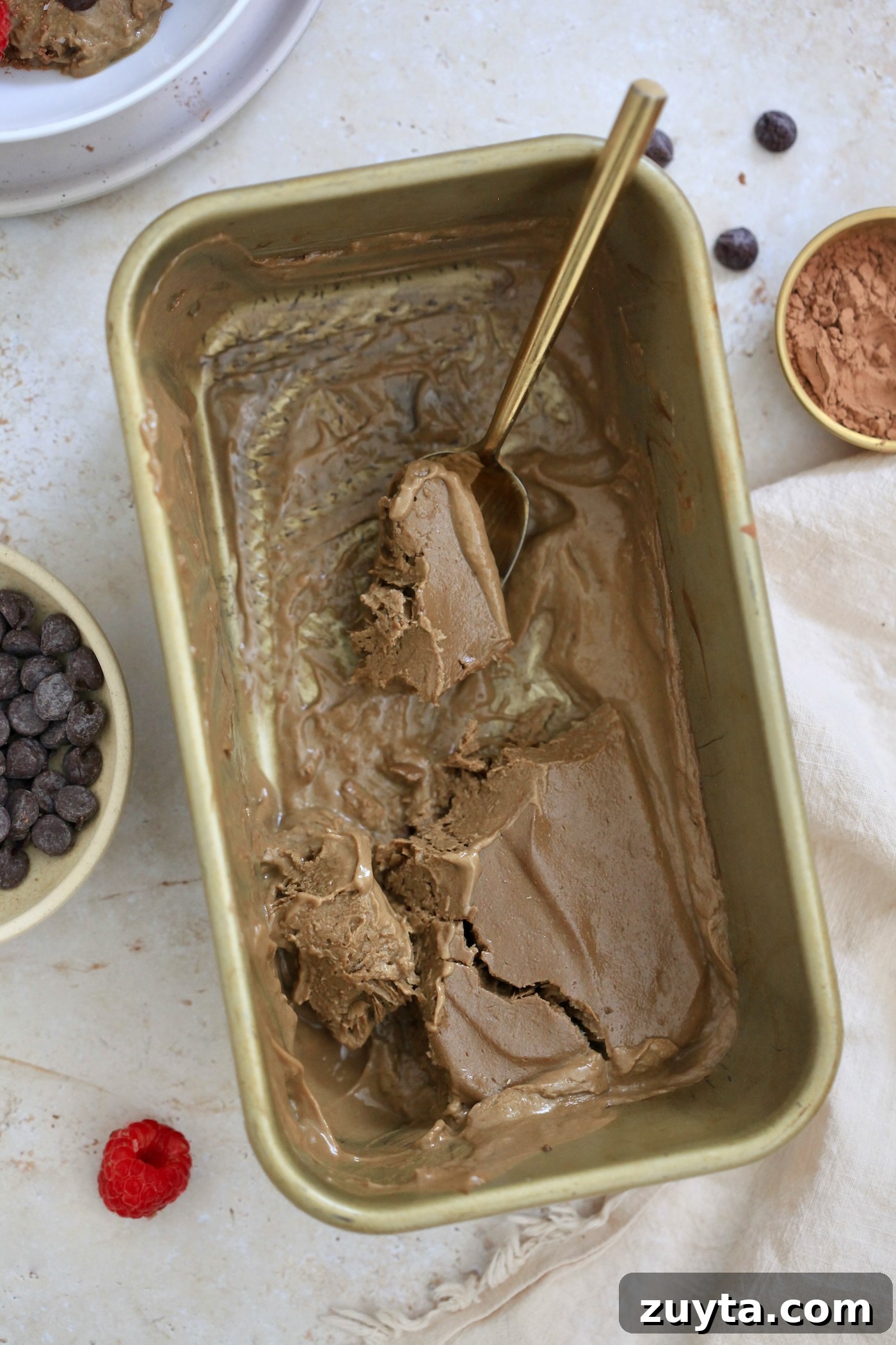 Creamy Dairy-Free Chocolate Avocado Ice Cream Recipe 6 loaf pan of half eaten chocolate ice cream with spoon