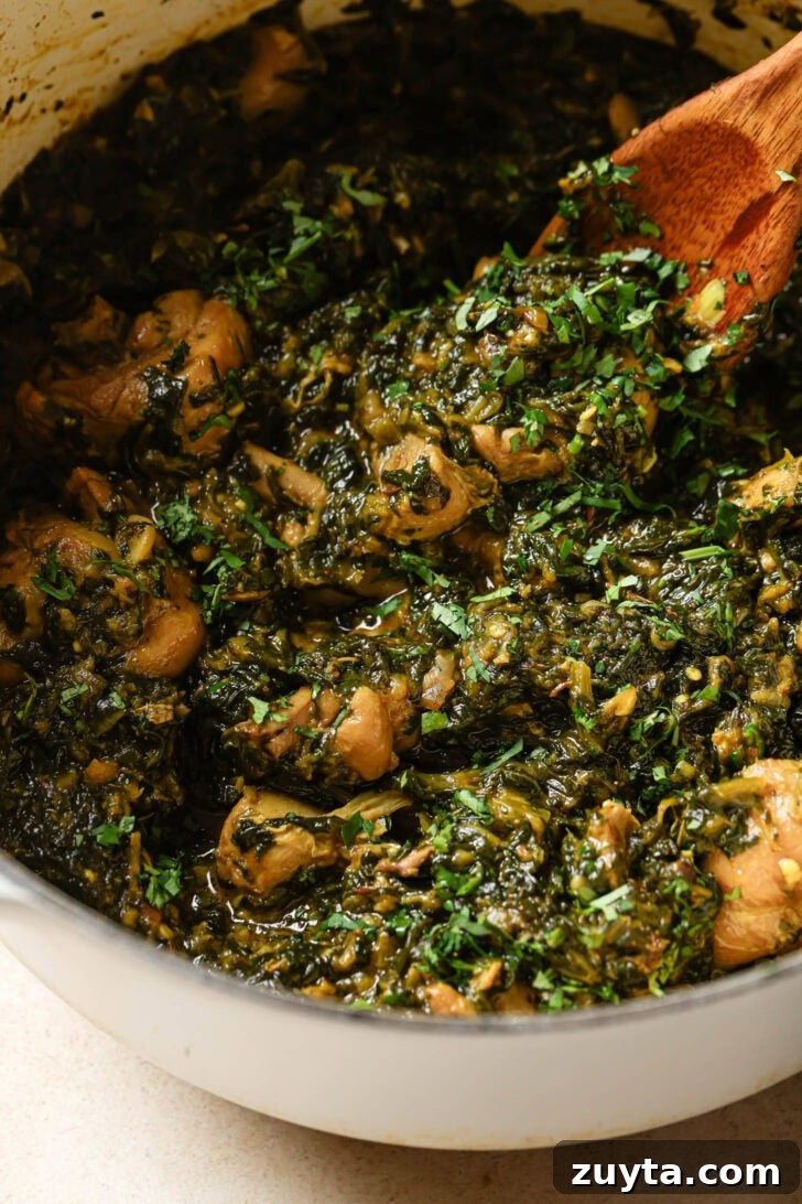 Creamy Chicken Saag with Spinach 6 Palak Chicken in a pot garnished with cilantro