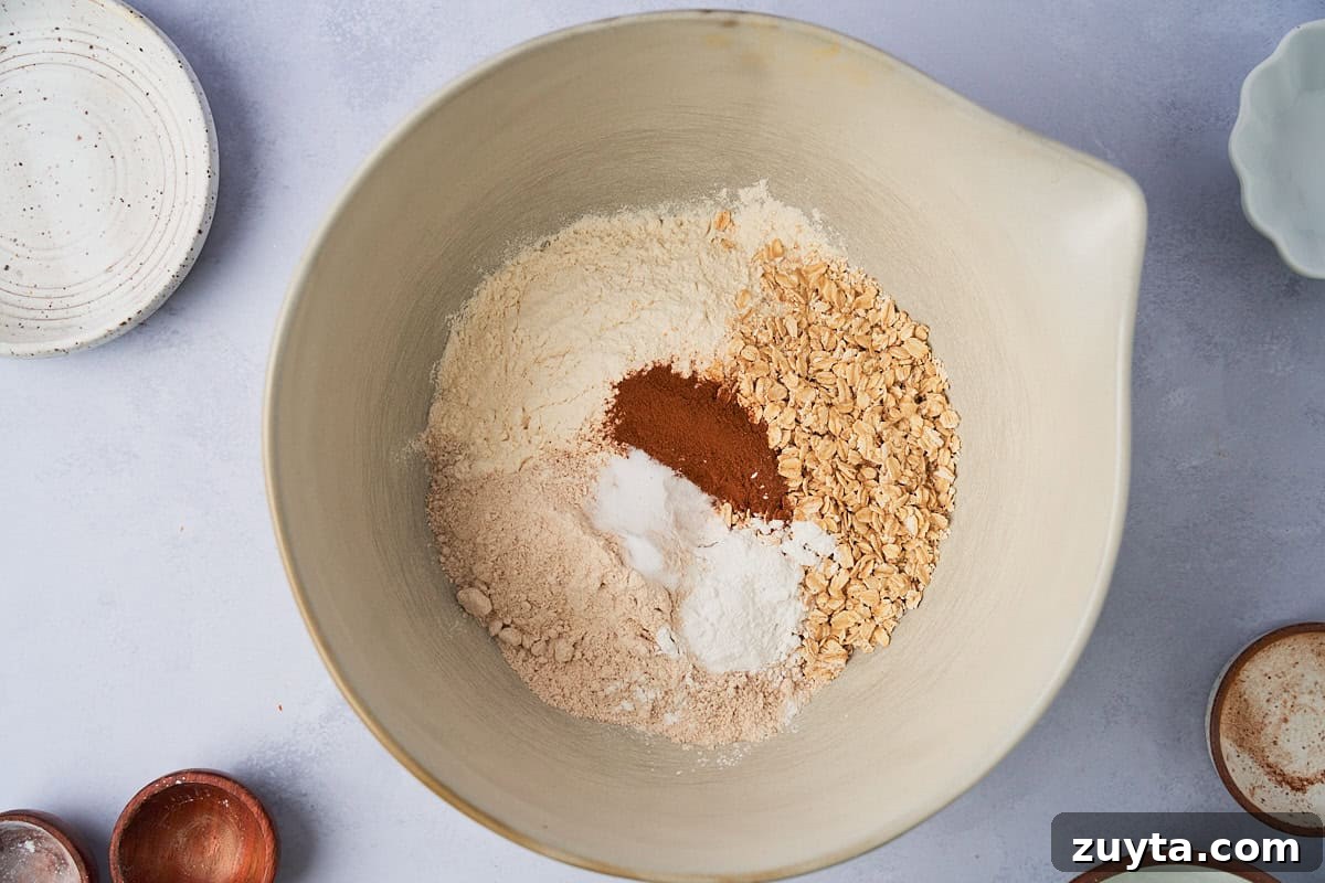 One-Bowl Zucchini Carrot Muffins Recipe 4 dry ingredients in a white mixing bowl