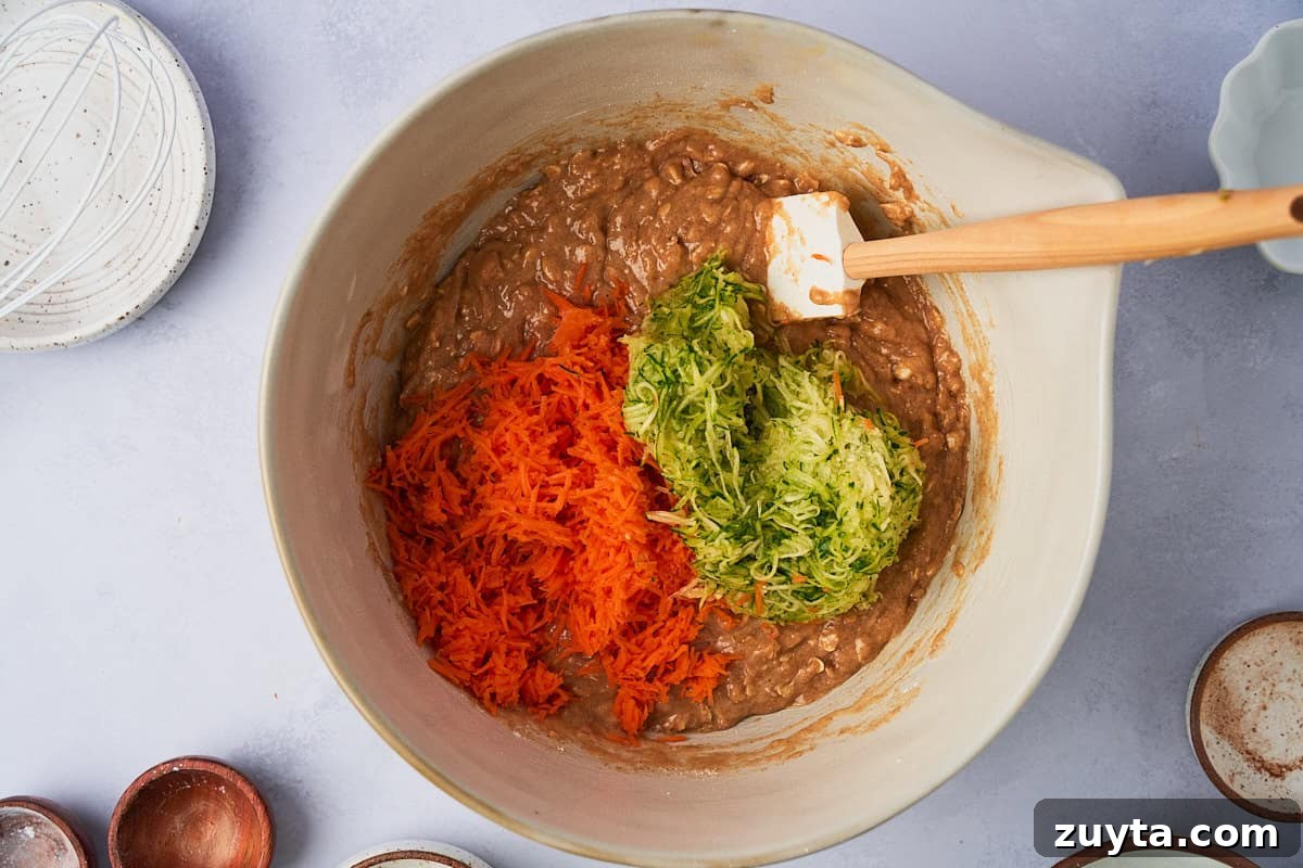 One-Bowl Zucchini Carrot Muffins Recipe 5 zucchini and carrots being added to muffin batter