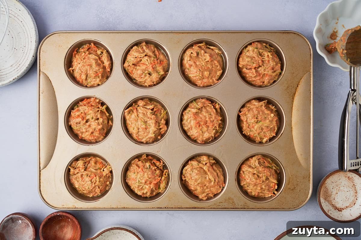 One-Bowl Zucchini Carrot Muffins Recipe 6 baked zucchini carrot muffins in a muffin tin
