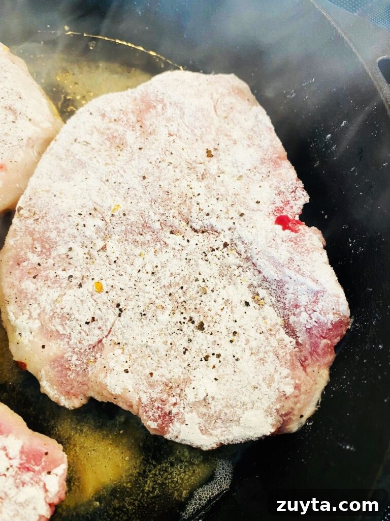 Apple Bourbon Glazed Pork Chops Recipe 3 breaded pork in skillet