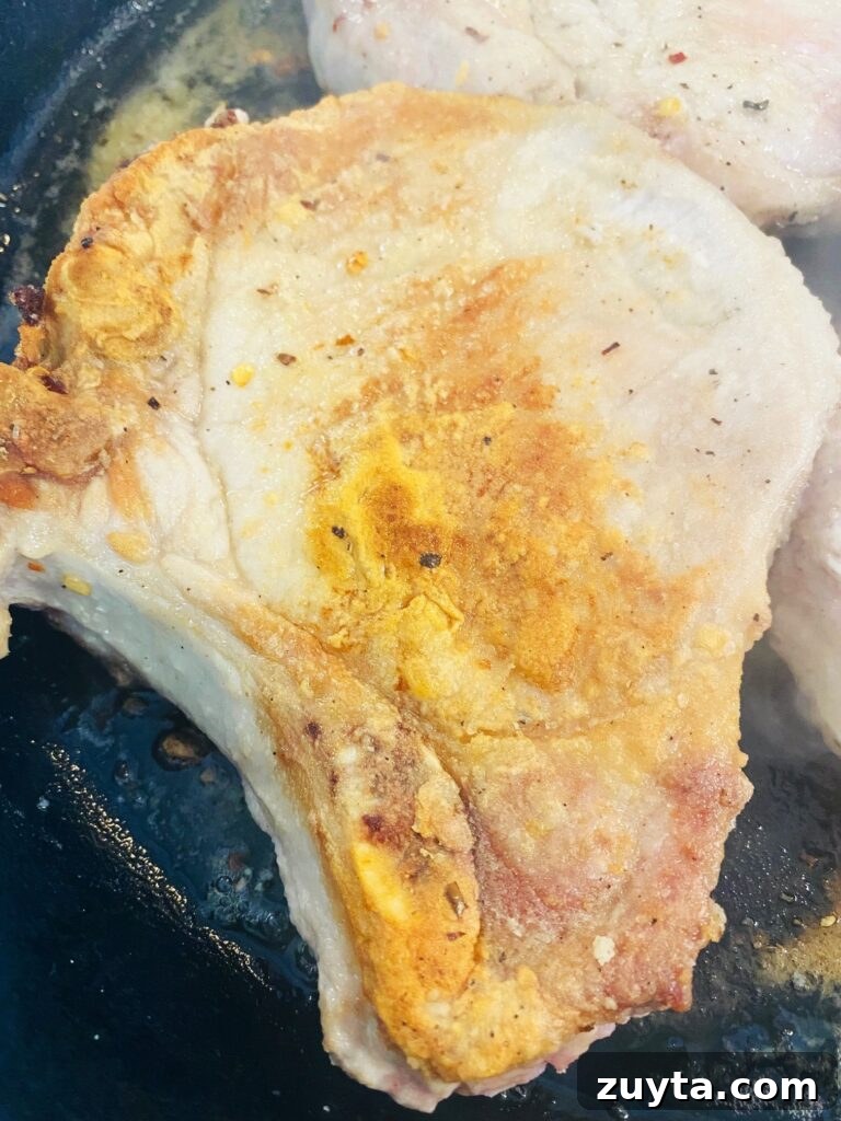 Apple Bourbon Glazed Pork Chops Recipe 4 cooked pork chop in skillet