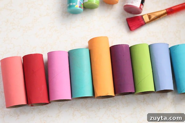 How to Make a Menorah from Toilet Paper Rolls 5 painted cardboard rolls lined up in a row