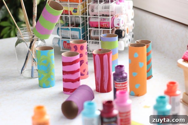How to Make a Menorah from Toilet Paper Rolls 6 painted cardboard rolls with stripes painted on
