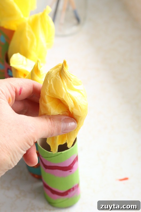 How to Make a Menorah from Toilet Paper Rolls 8 putting tissue paper flame in cardboard roll menorah candle
