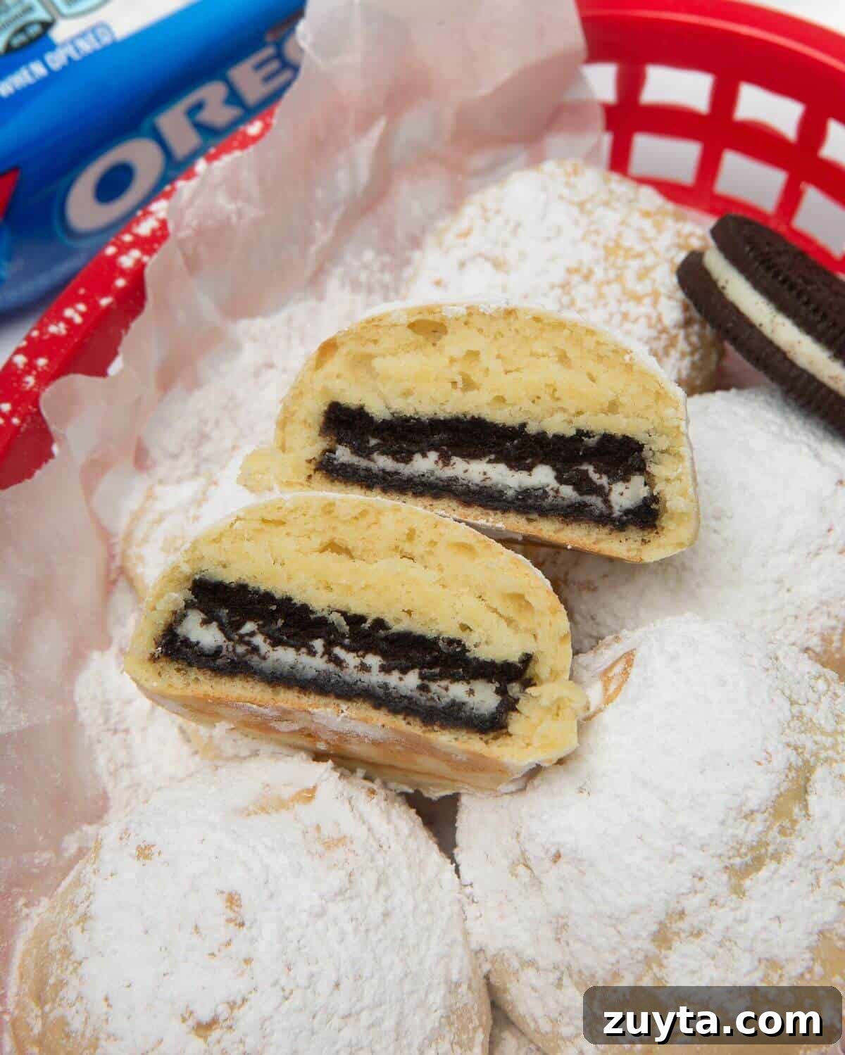 Air Fryer Oreos Recipe: Crispy, Gooey Dessert 12 air fried oreo cut in half in red basket with powdered sugar