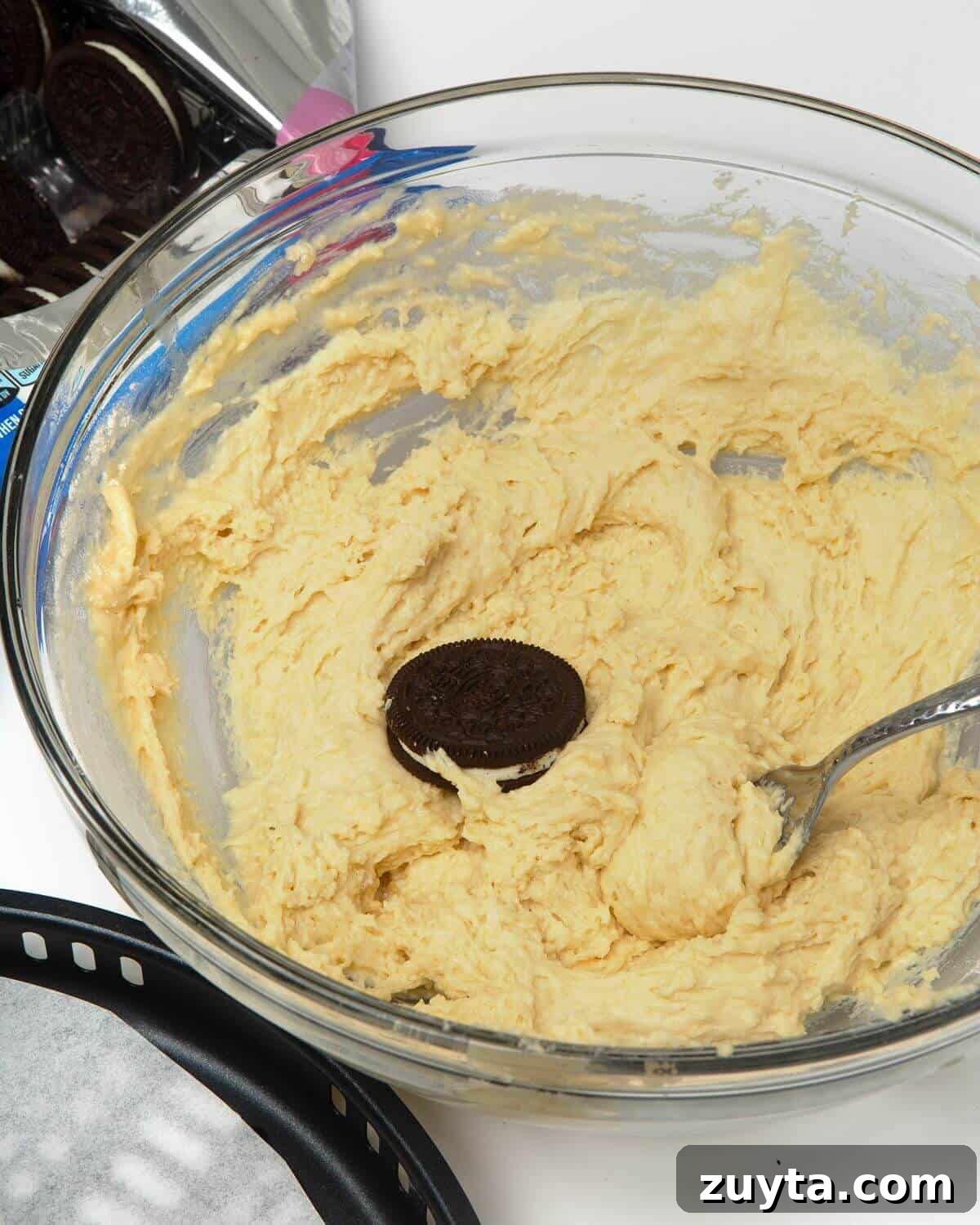 Air Fryer Oreos Recipe: Crispy, Gooey Dessert 7 pancake batter in glass mixing bowl with oreo and fork