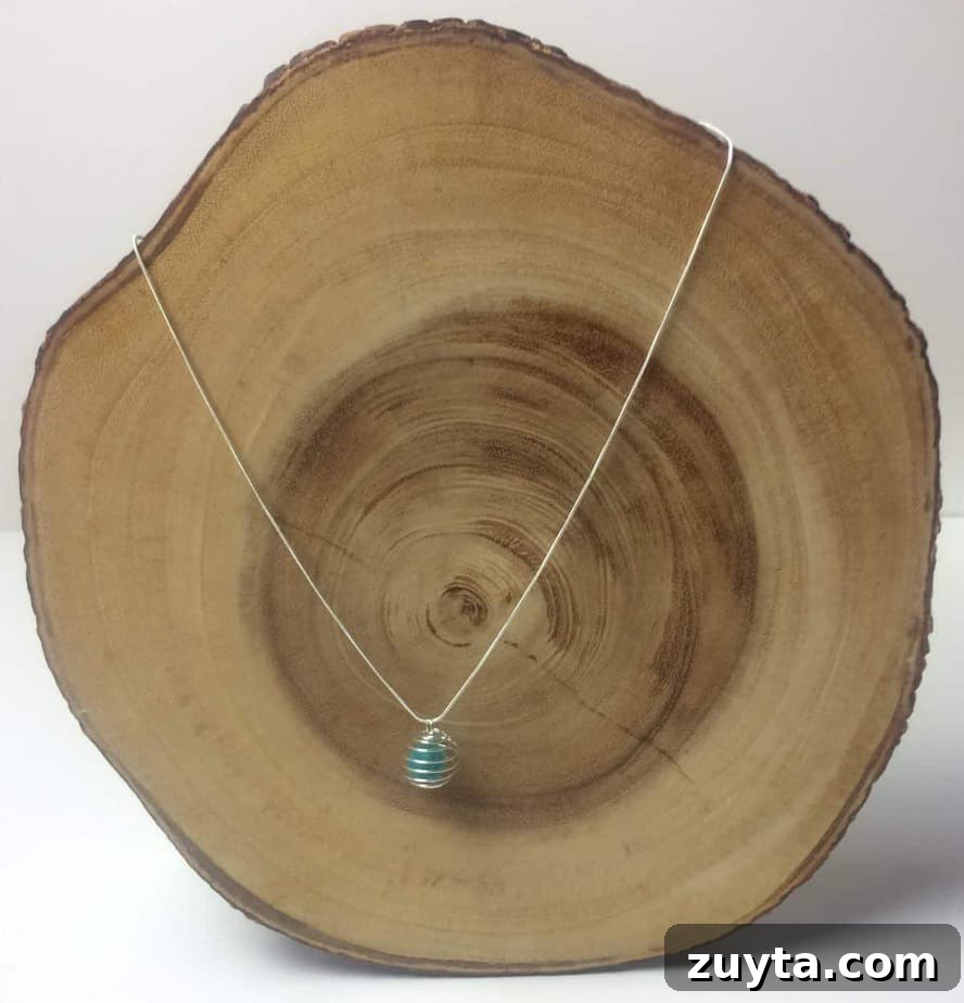 How to Make an Essential Oil Diffuser Necklace 14 essential oil diffuser necklace displayed on slice of cedar tree to show what it would look like on neck
