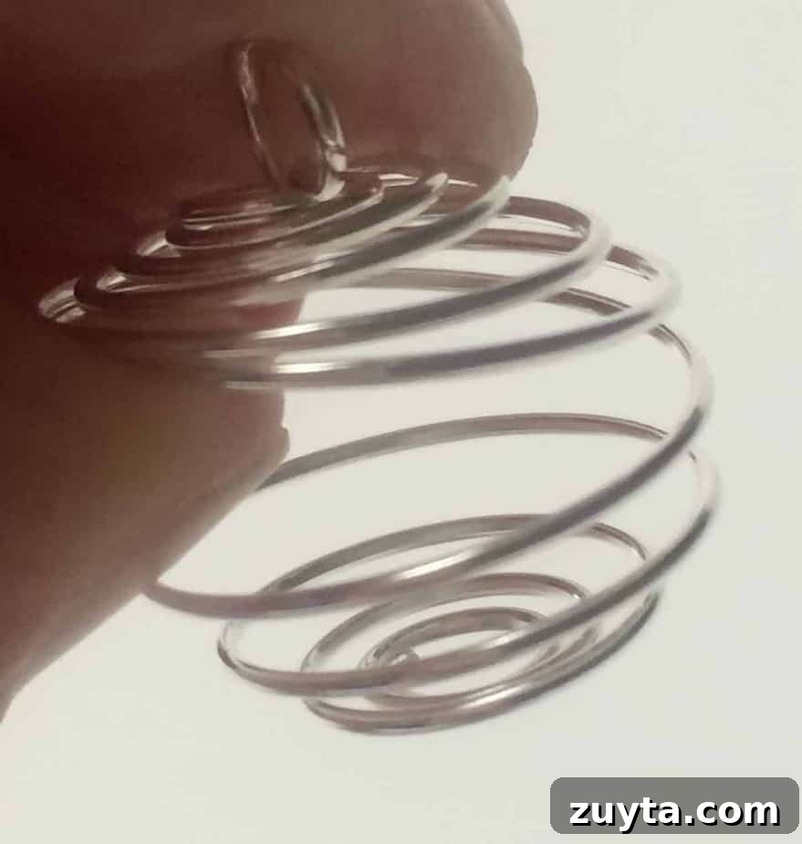 How to Make an Essential Oil Diffuser Necklace 9 use fingers to pry open wire cage big enough to fit wool ball