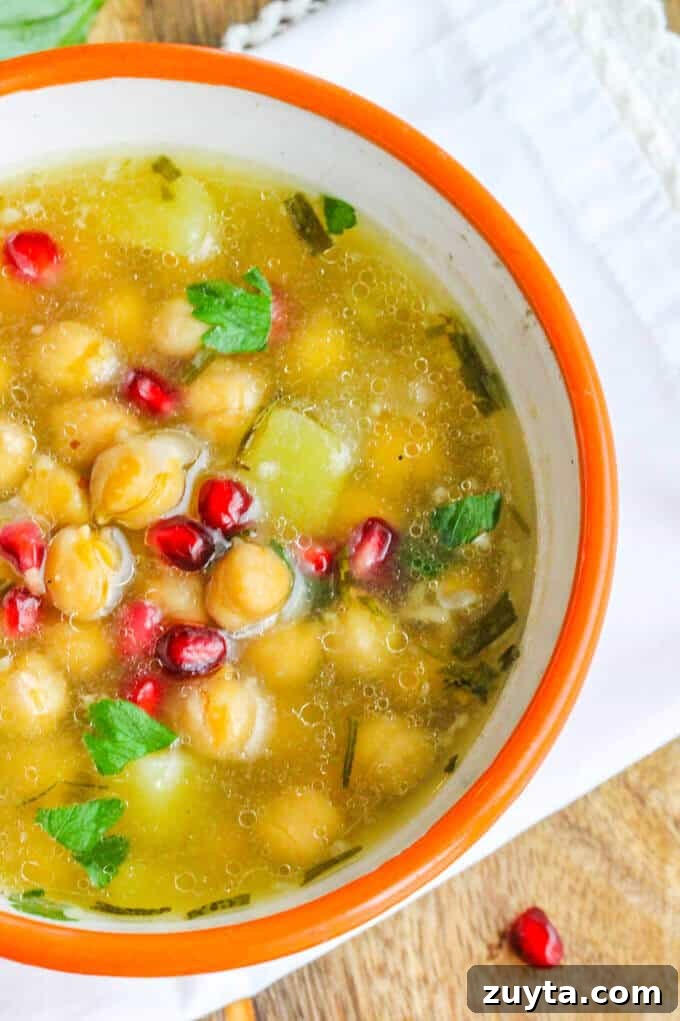 Greek Chickpea Soup ('Revithosoupa') is a traditional Greek vegan soup that uses simple ingredients. This version uses canned chickpeas and is ready in 20 minutes. Greek Chickpea Soup in a bowl with kitchen towel on a side