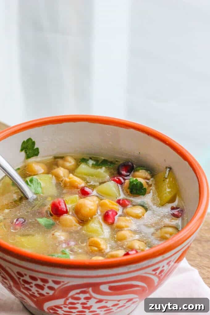 Greek Chickpea Soup ('Revithosoupa') is a traditional Greek vegan soup that uses simple ingredients. This version uses canned chickpeas and is ready in 20 minutes. Revithosoupa in a bowl with spoon