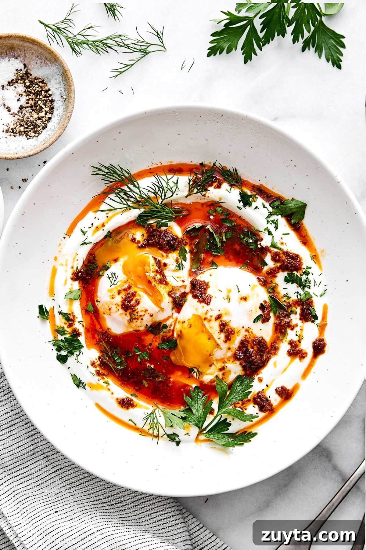Over 60 Mediterranean Diet Recipes for Every Meal 22 A plate of Turkish eggs with herbs.