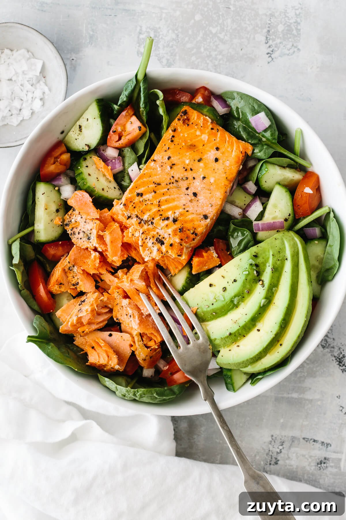 Over 60 Mediterranean Diet Recipes for Every Meal 41 Salmon filet on salad with avocado slices.
