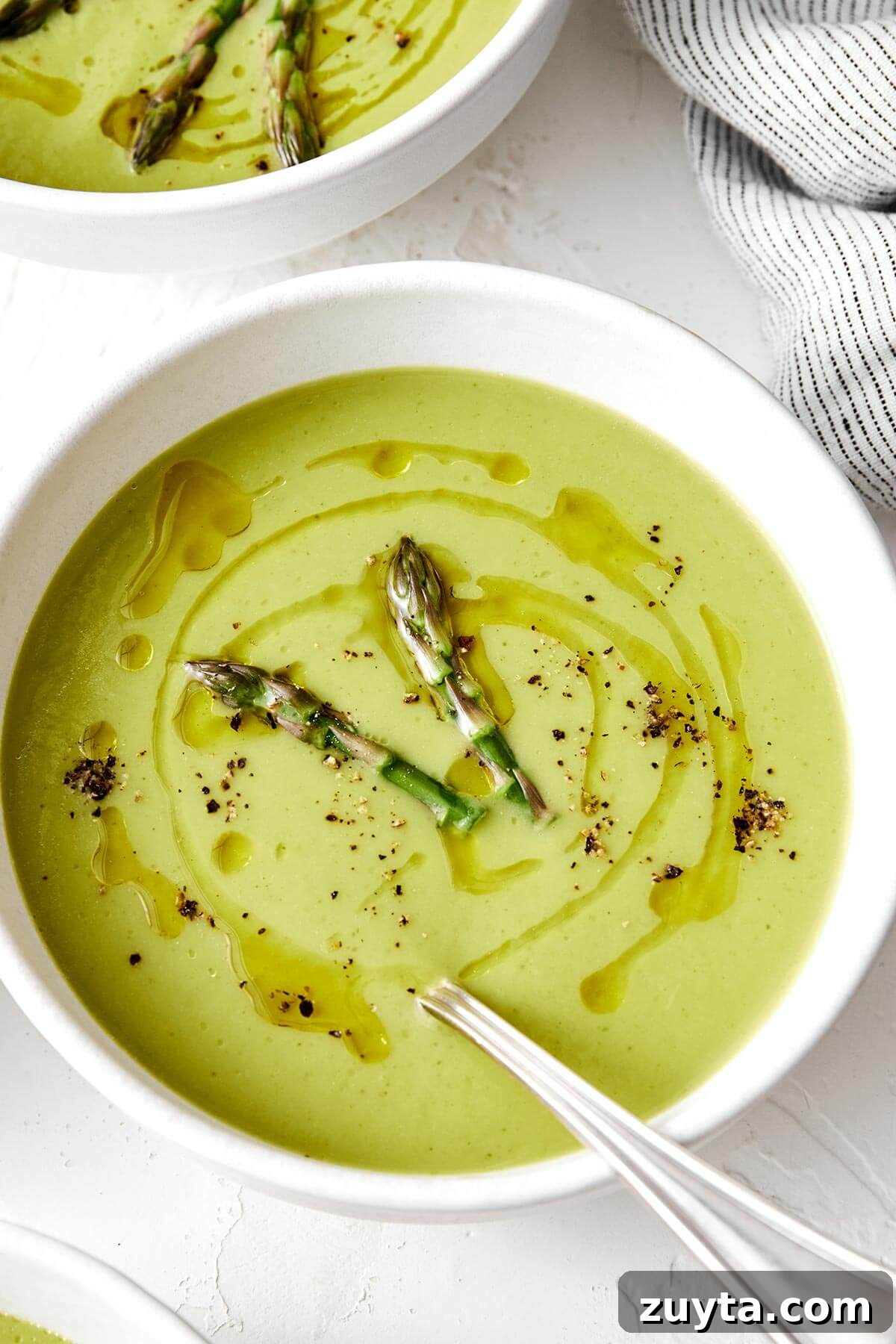Over 60 Mediterranean Diet Recipes for Every Meal 51 Creamy asparagus soup in a bowl.