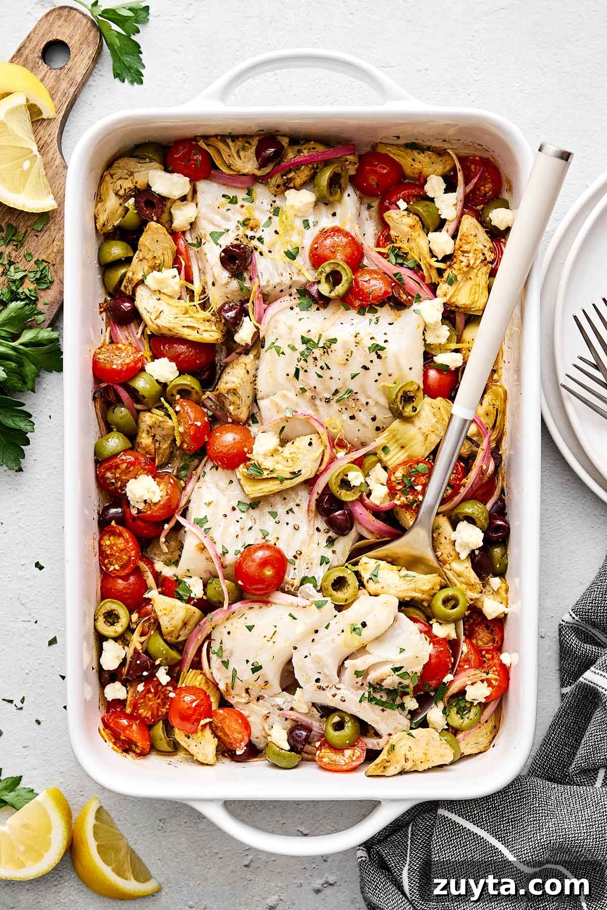 Over 60 Mediterranean Diet Recipes for Every Meal 59 Greek baked cod with vegetables in a casserole pan.