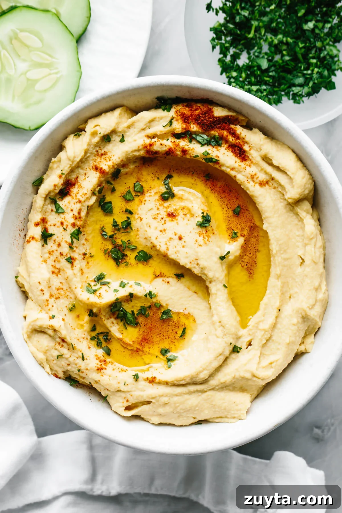 Over 60 Mediterranean Diet Recipes for Every Meal 7 A bowl of homemade hummus next to a napkin