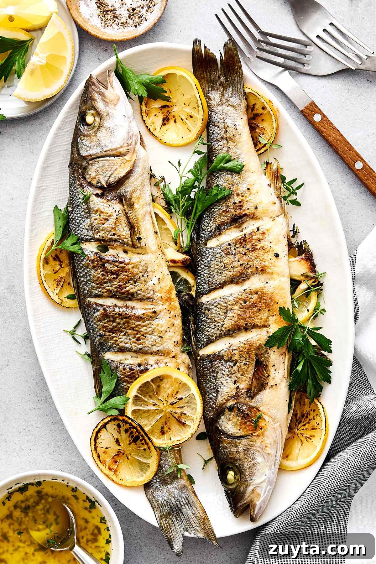 Over 60 Mediterranean Diet Recipes for Every Meal 61 Whole roasted branzino on a plate.