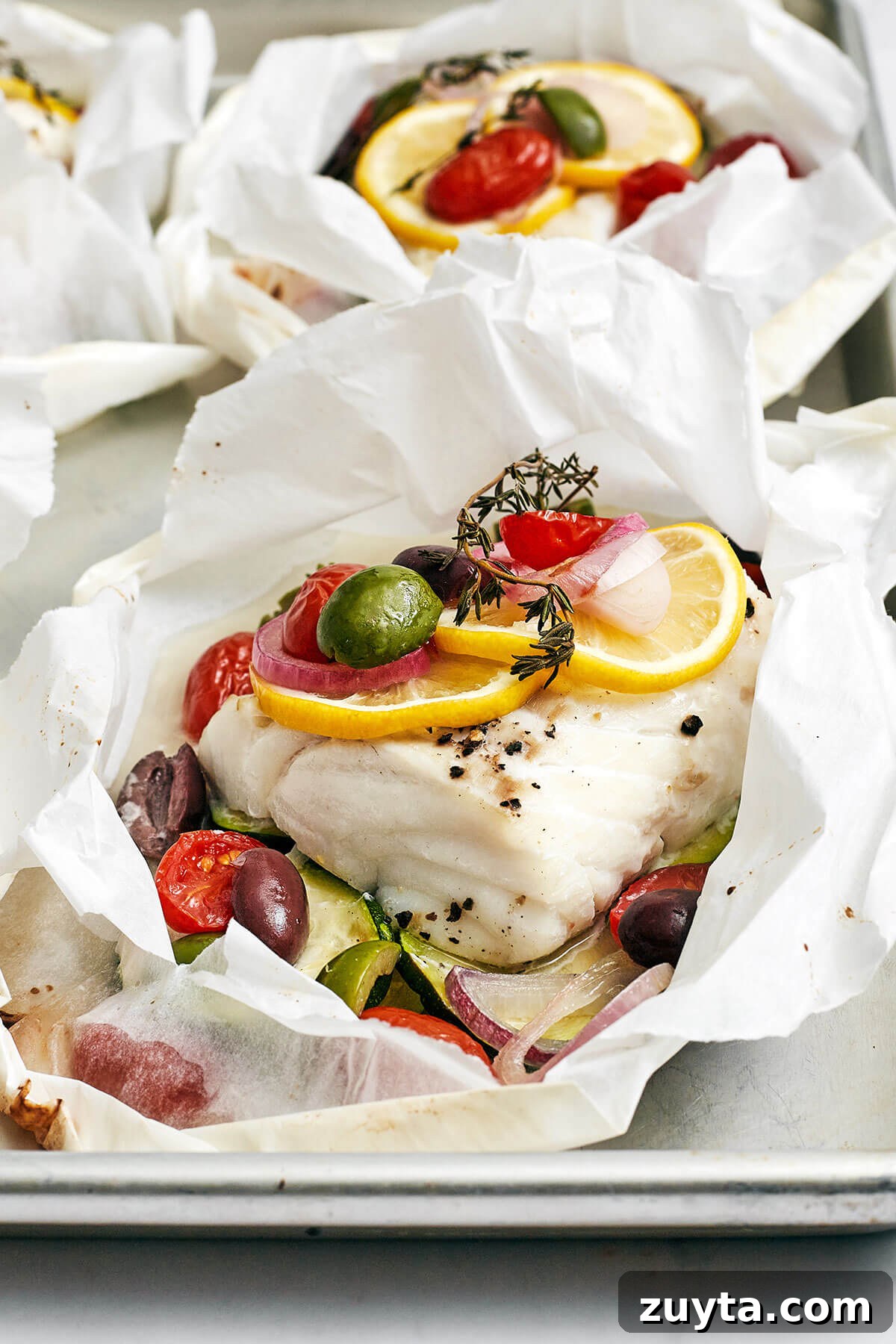 Over 60 Mediterranean Diet Recipes for Every Meal 62 Mediterranean cod en papillote on a baking sheet
