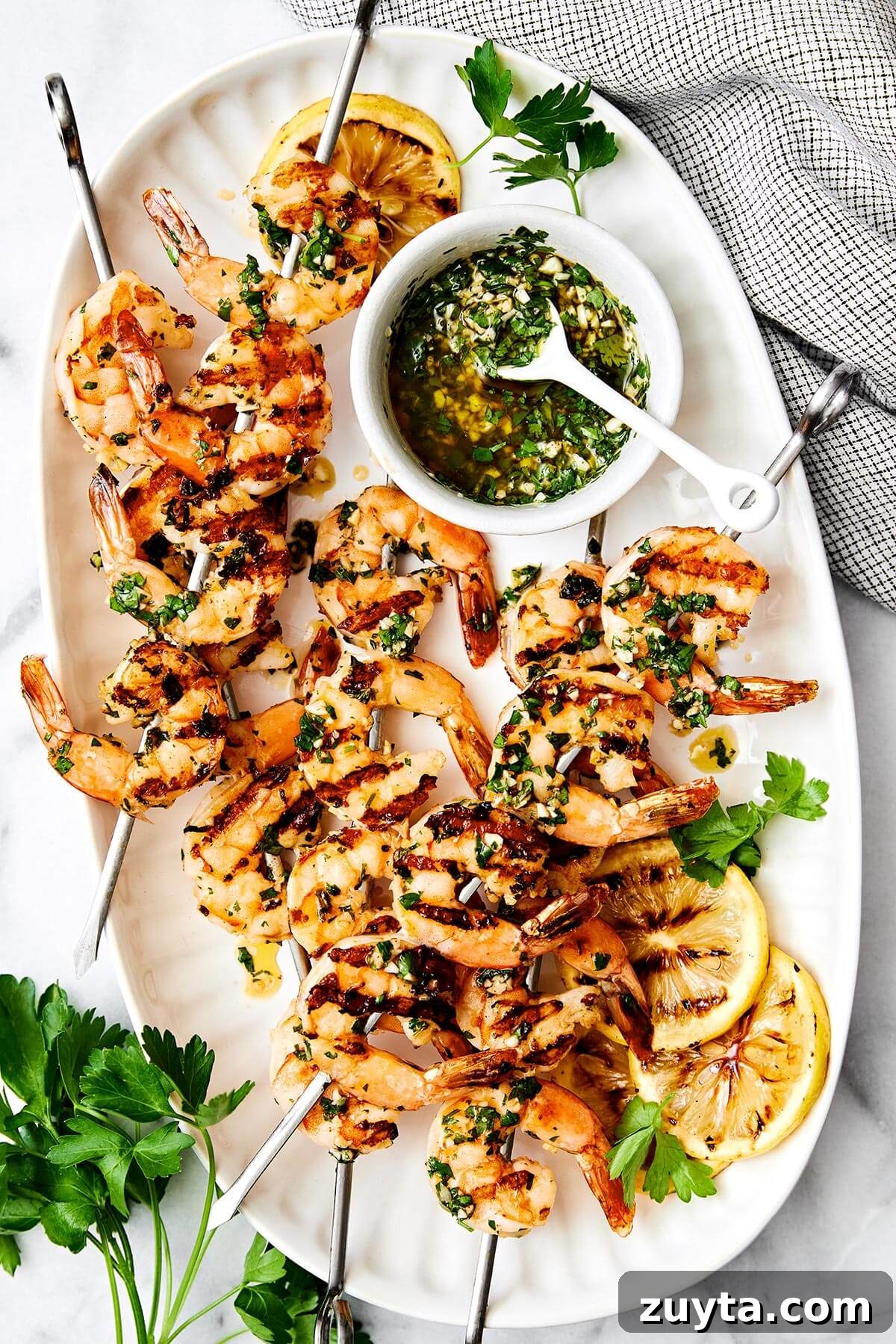 Over 60 Mediterranean Diet Recipes for Every Meal 65 A plate of grilled shrimp skewers.