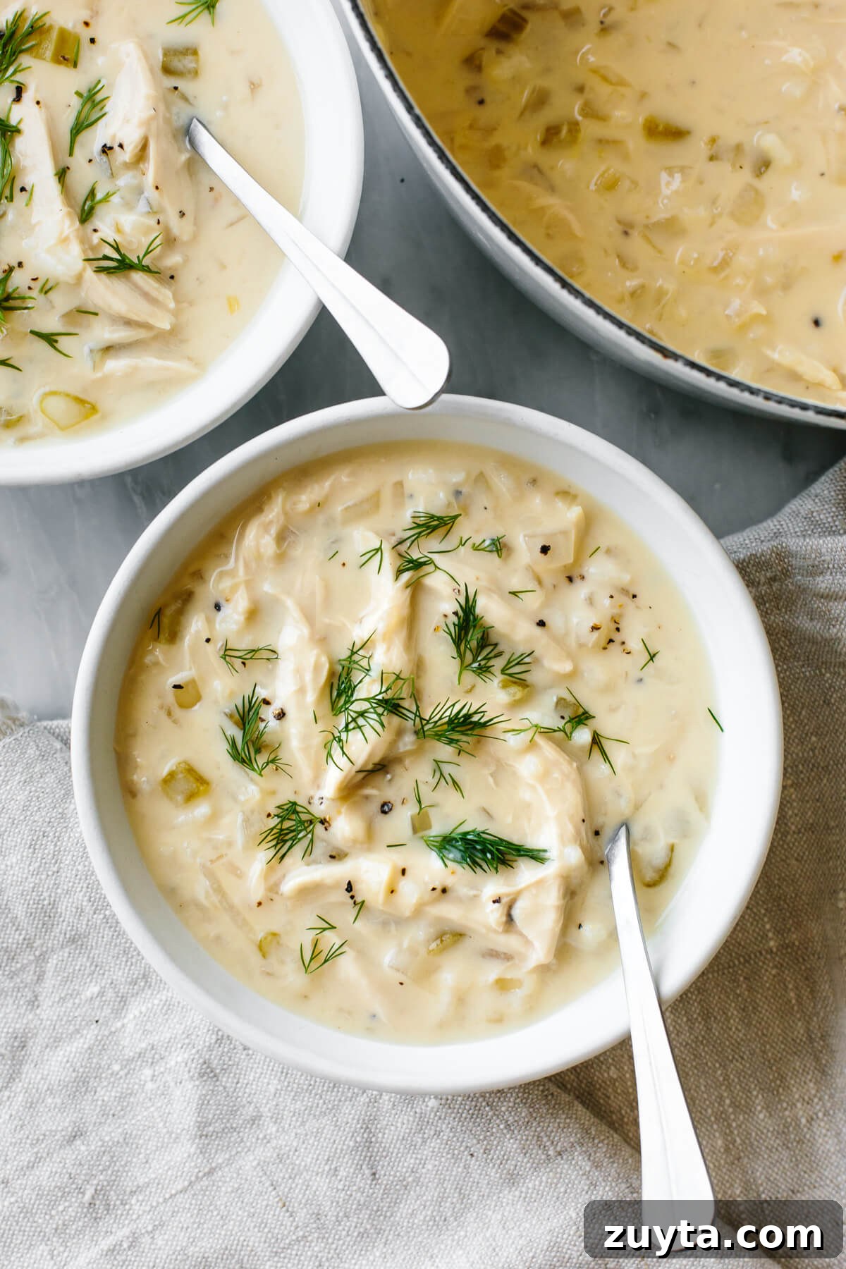 Over 60 Mediterranean Diet Recipes for Every Meal 75 Avgolemono soup in a white bowl with a spoon