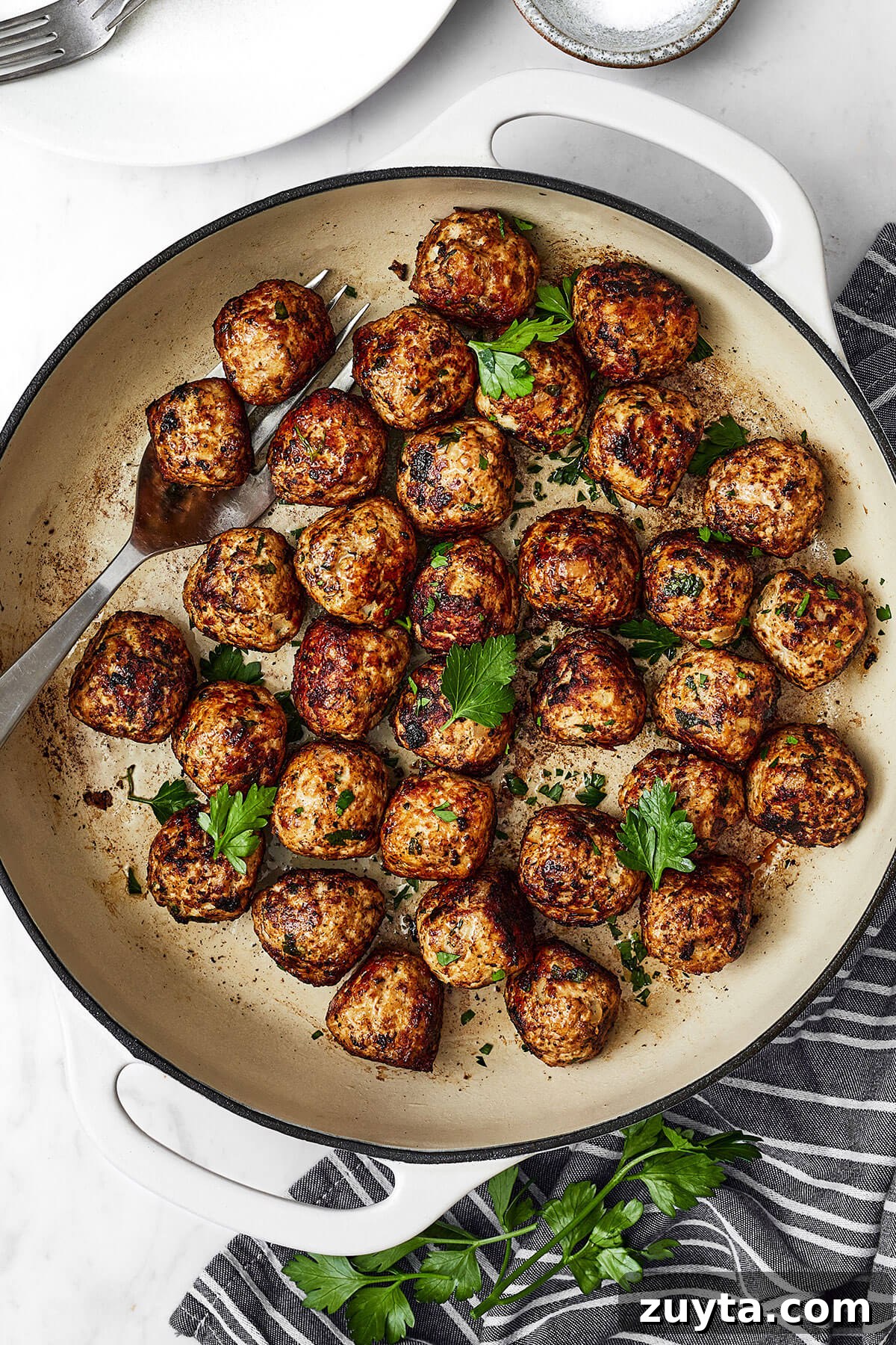 Over 60 Mediterranean Diet Recipes for Every Meal 81 A white pan of fennel pork meatballs next to a napkin