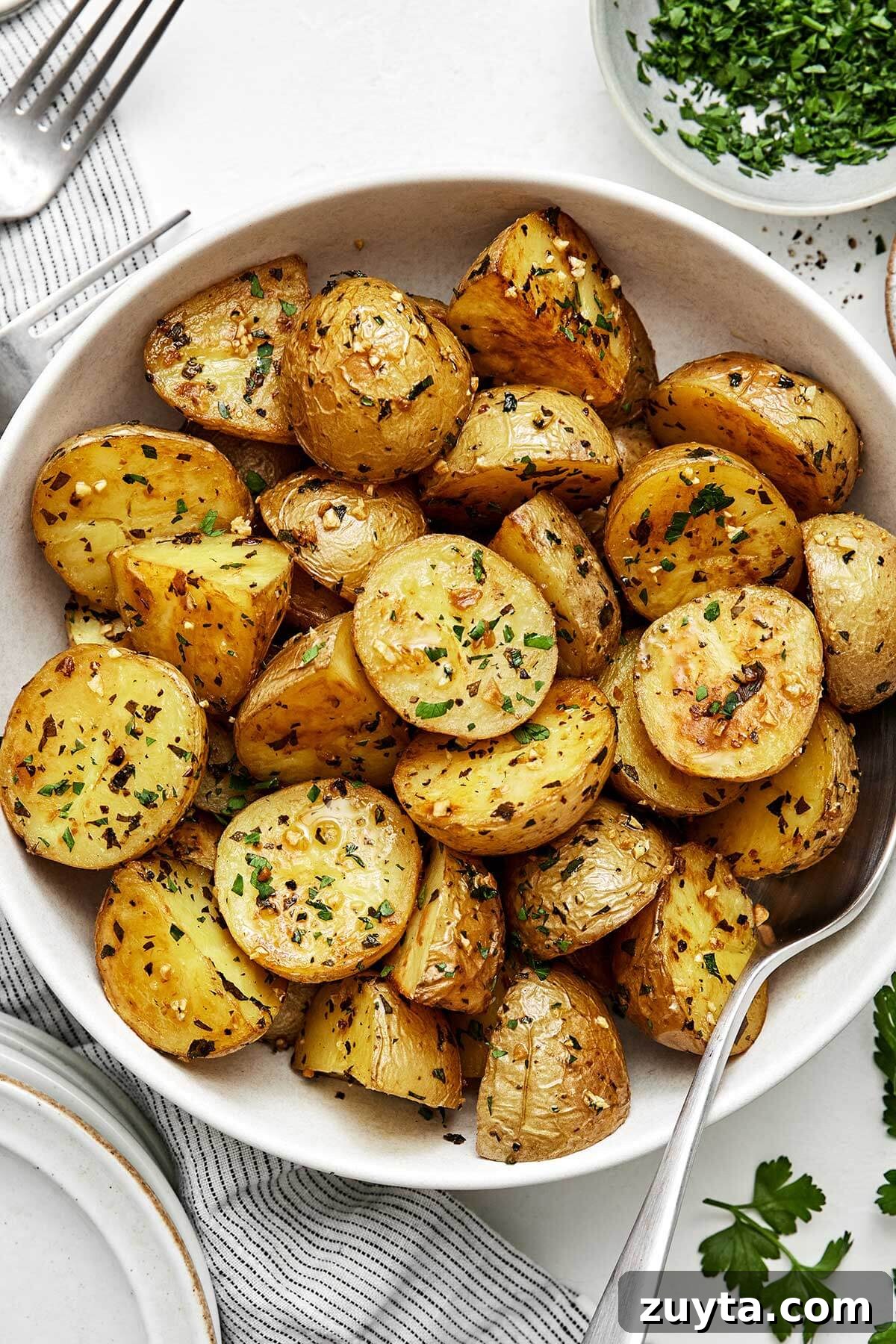 Over 60 Mediterranean Diet Recipes for Every Meal 86 Garlic roasted potatoes in a bowl.