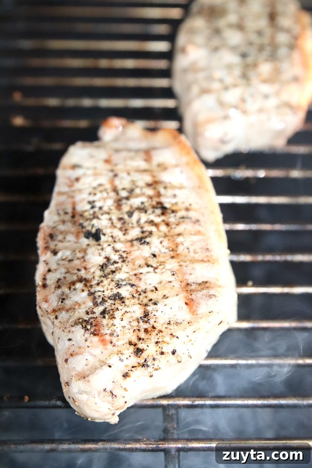 How to grill juicy pork chops closeup of pork chops on a grill
