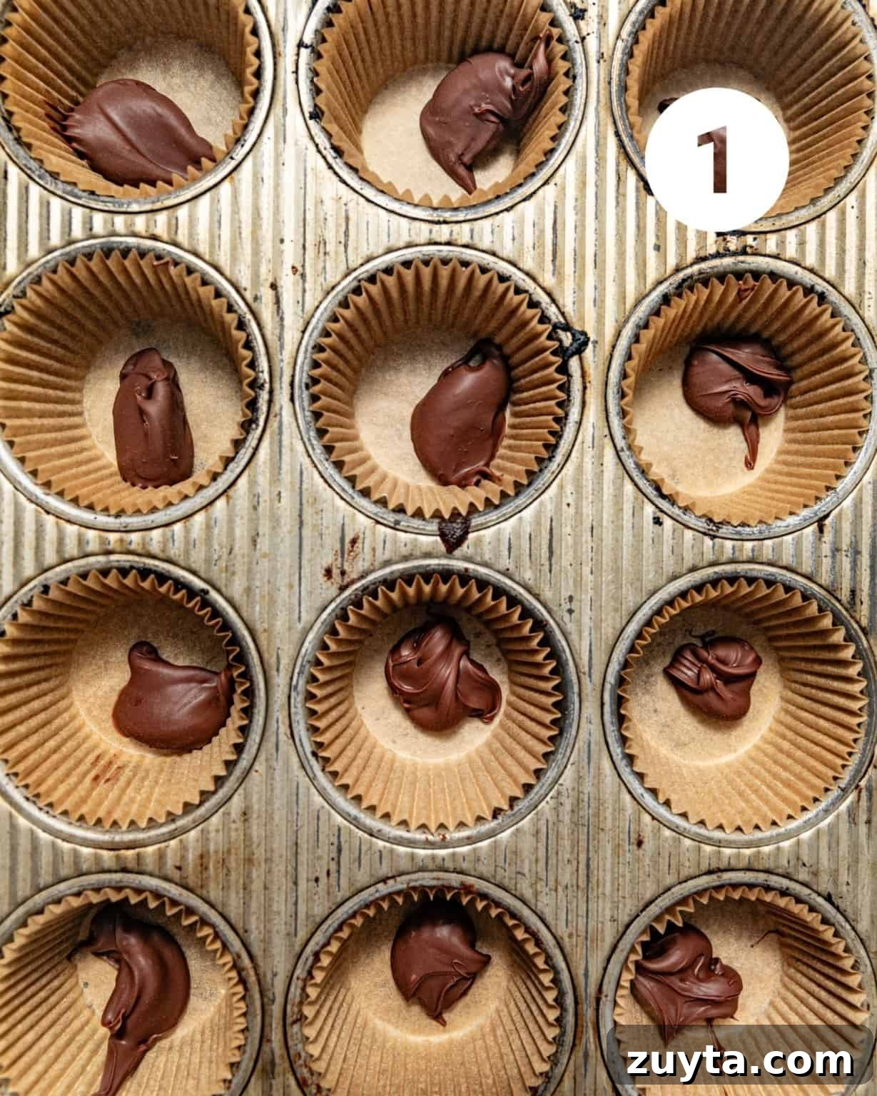 nutella placed into the center of a muffin lined cupcake pan