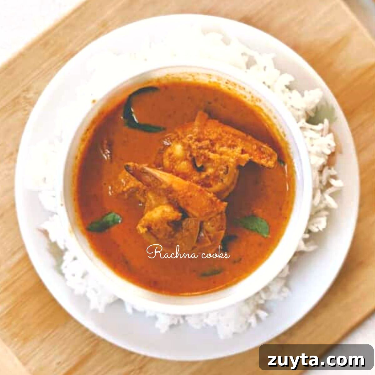 Mangalorean Prawn Gassi: Authentic Coconut Prawn Curry 3 Prawn gassi served in a white bowl with rice on the side.