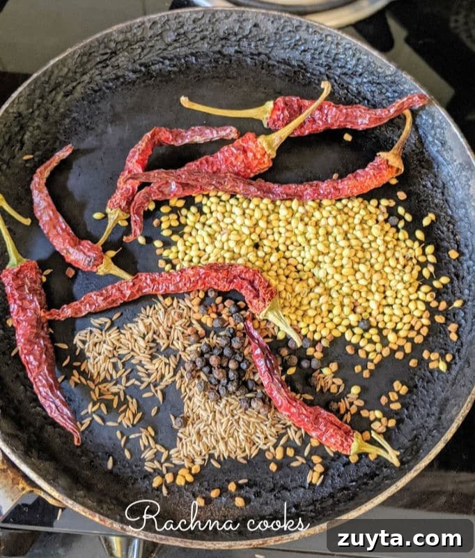 Mangalorean Prawn Gassi: Authentic Coconut Prawn Curry 4 Dry spices coriander seeds, cumin seeds, peppercorn, red chillies and fenugreek seeds being dry roasted on a tawa