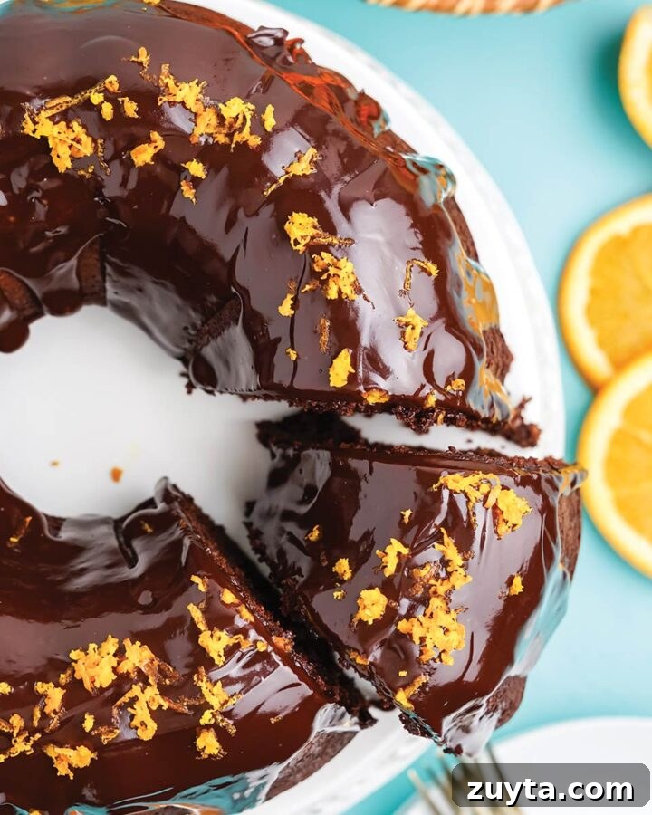 Copycat Cracker Barrel Coca-Cola Cake Recipe 11 Chocolate orange bundt cake on the table with a piece cut and being served.