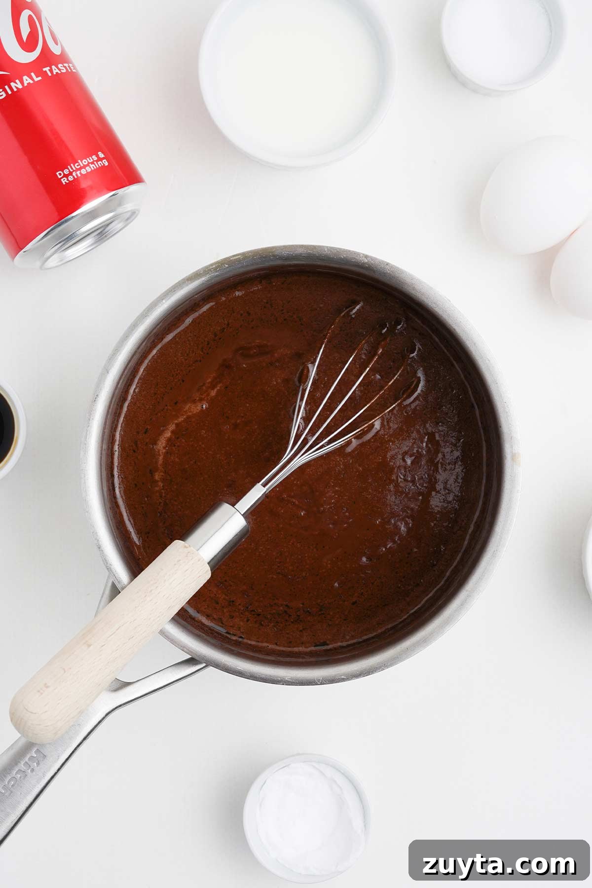 Copycat Cracker Barrel Coca-Cola Cake Recipe 6 The cola reduction for coca cola cake in a saucepan.