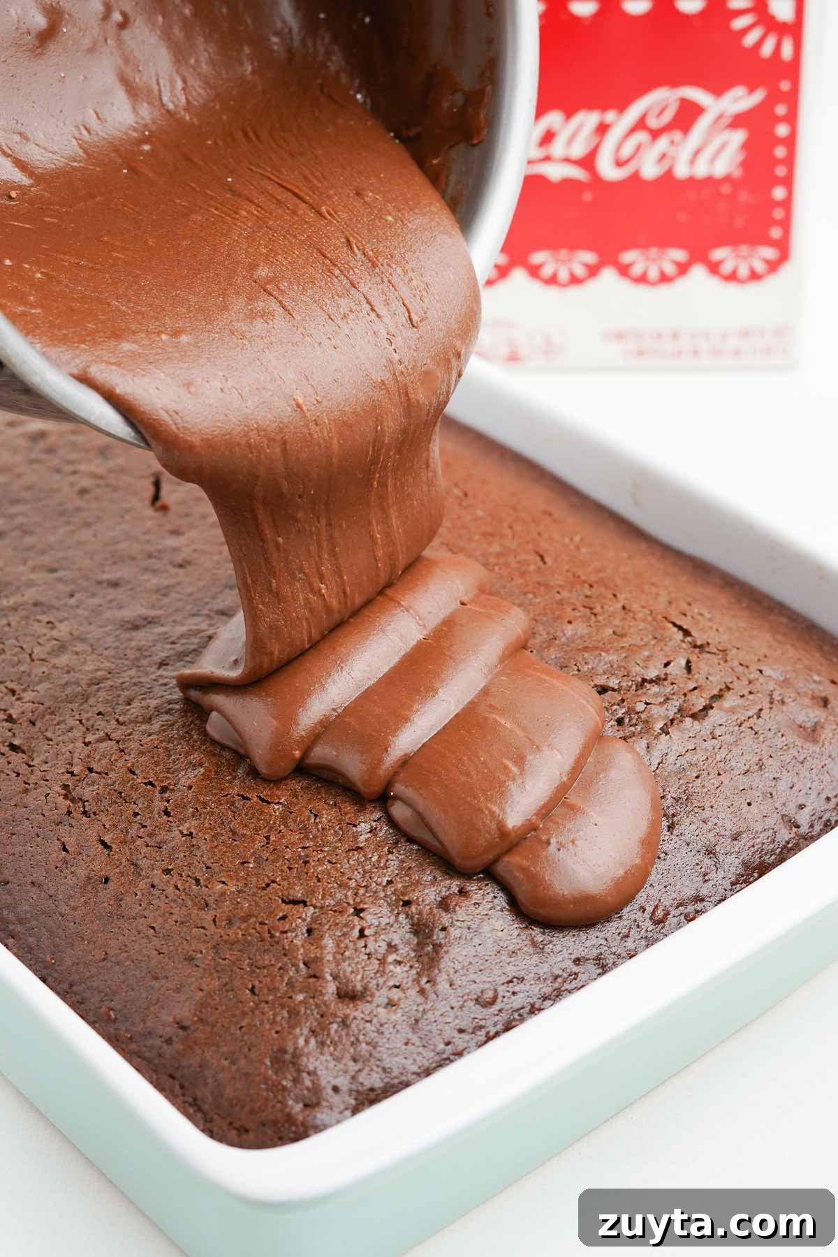 Copycat Cracker Barrel Coca-Cola Cake Recipe 8 Pouring the icing over the top of the coca cola cake.