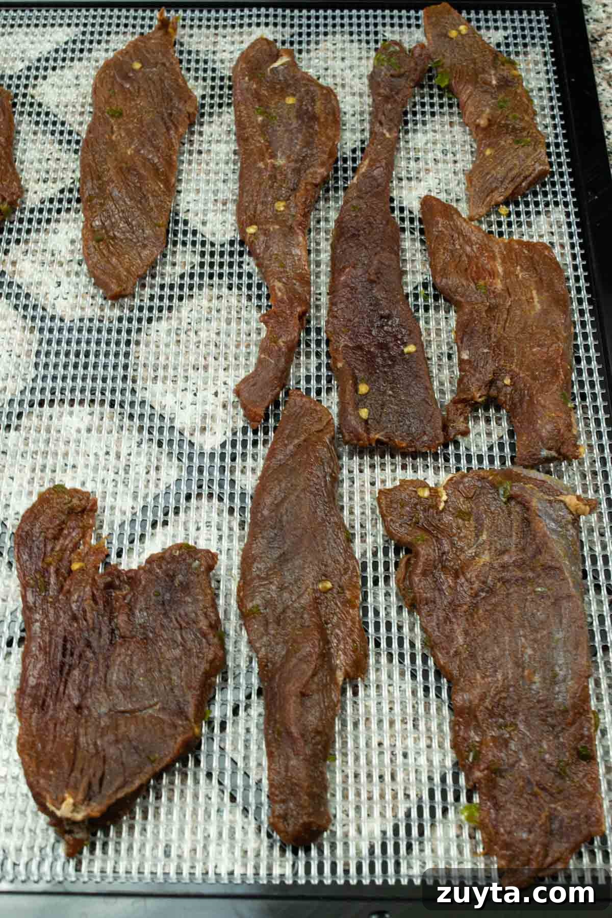Homemade Asian-Spiced Venison Jerky Recipe 5 venison jerky drying on dehydrator trays