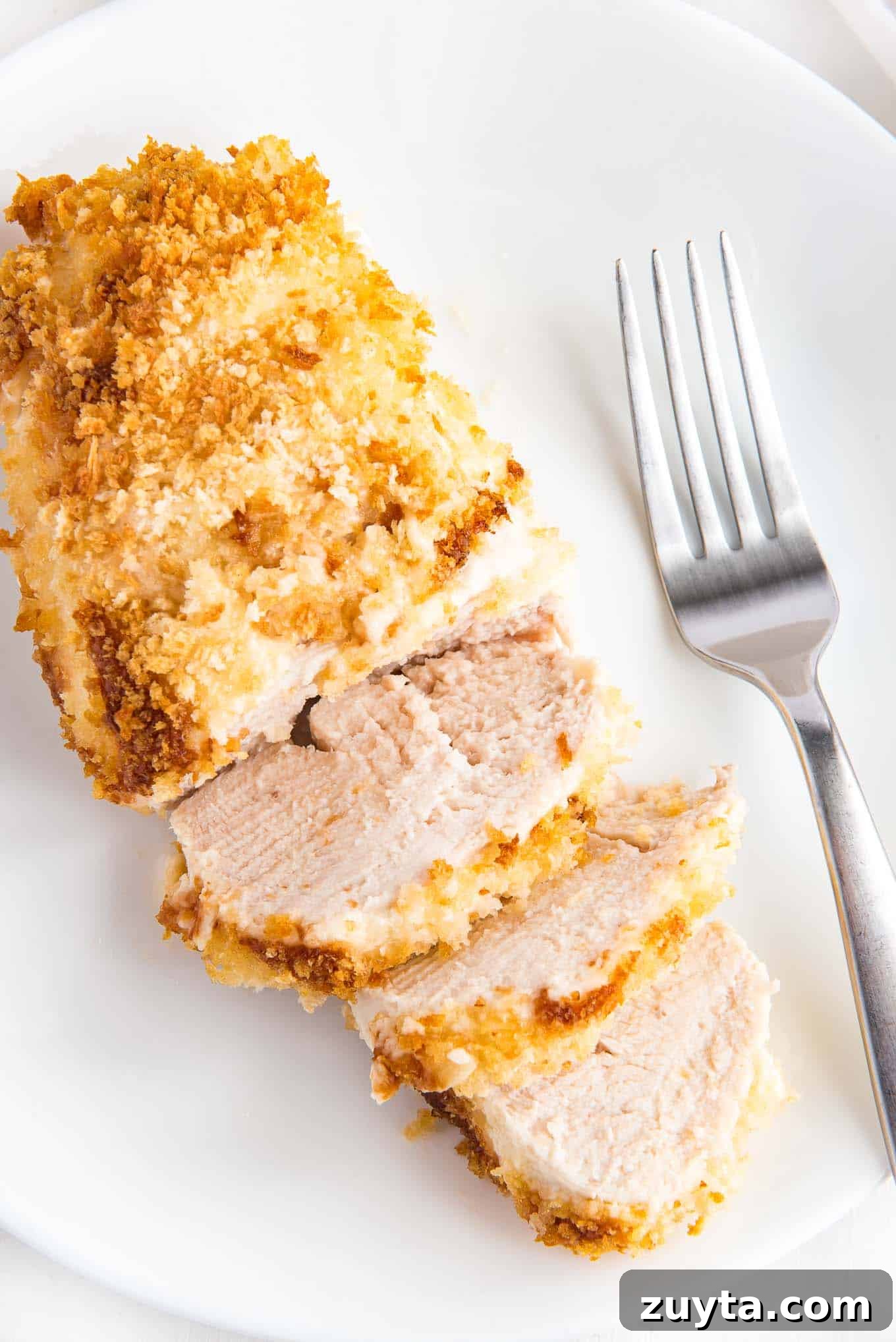 4-Ingredient Crispy Panko Chicken Recipe 2 A piece of crispy panko chicken on a plate with a fork to the side.